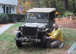 H&S Company: T/Sgt. William G. Leunig of Red Hook, Brooklyn, NY, re-enacting his jeep repair 60 years later on a restored 285 ECB jeep on Long Island, NY.  T/Sgt. Leunig passed away at age 100 on Veterans Day 2020